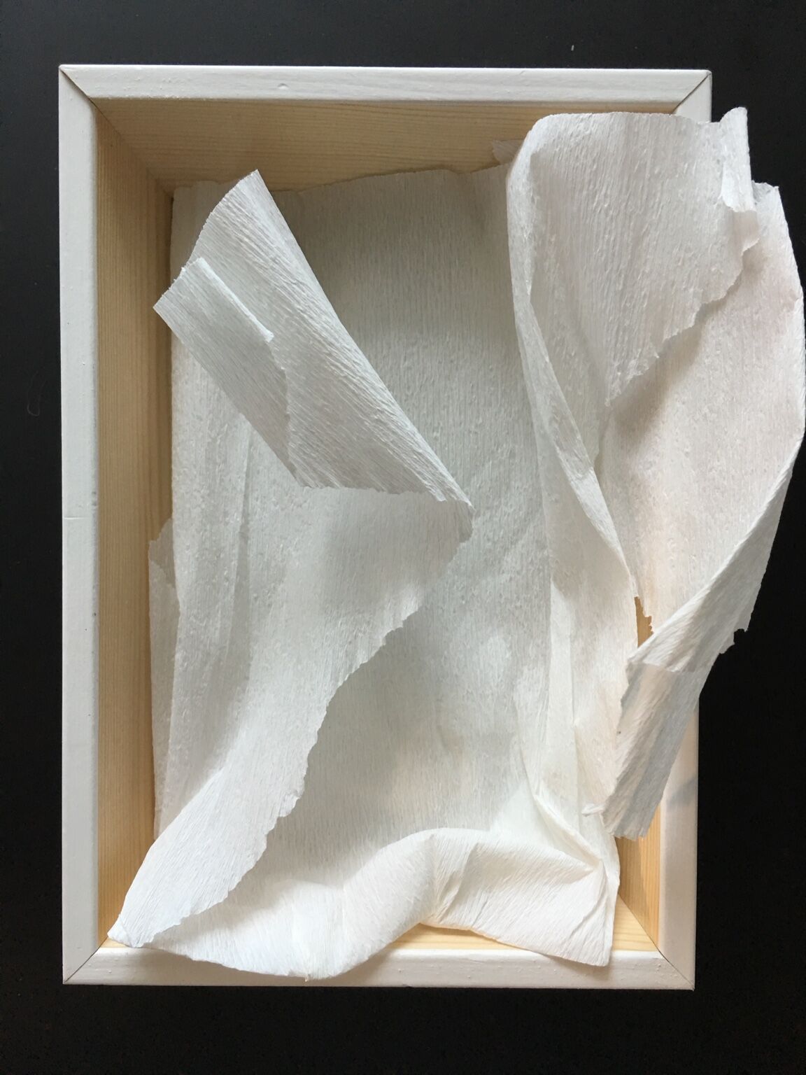 El Todo y la Nada by José Cosme, white sculptural fragment presented inside a wooden frame
